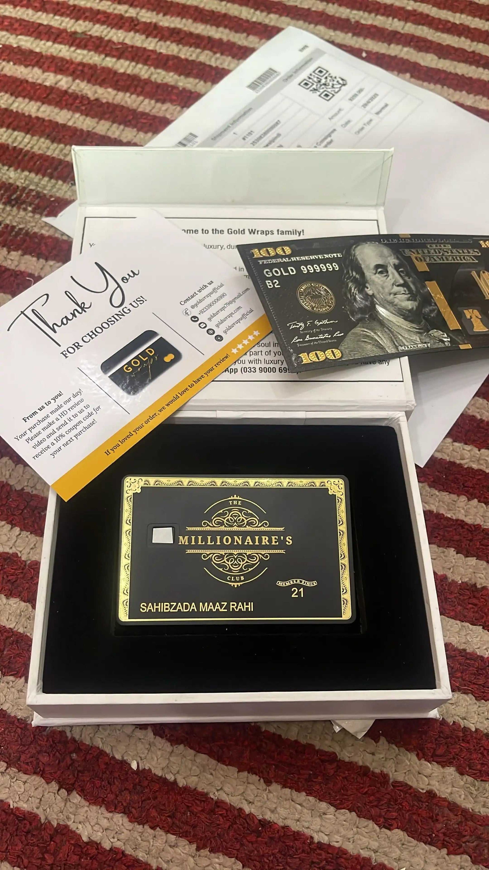 Luxury black and gold metal card in gift box with thank you note and gold-themed card.