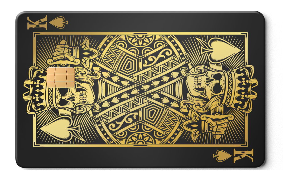 Gold King of Spades metal card with skull design and chip on matte black background