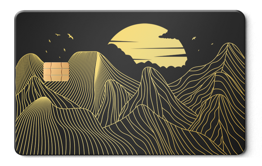 Metal card with gold mountain line art and sun design on matte black background