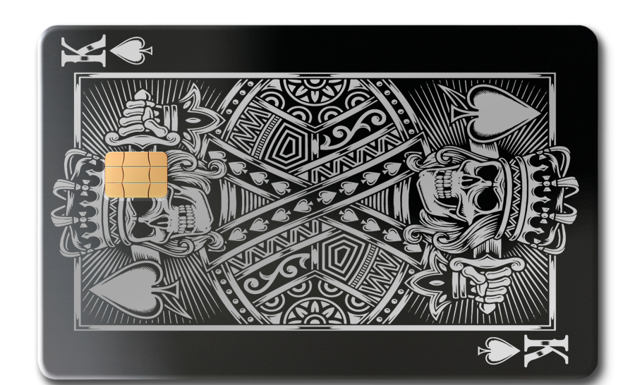 Black metal card featuring king of spades design with skull motifs and EMV chip