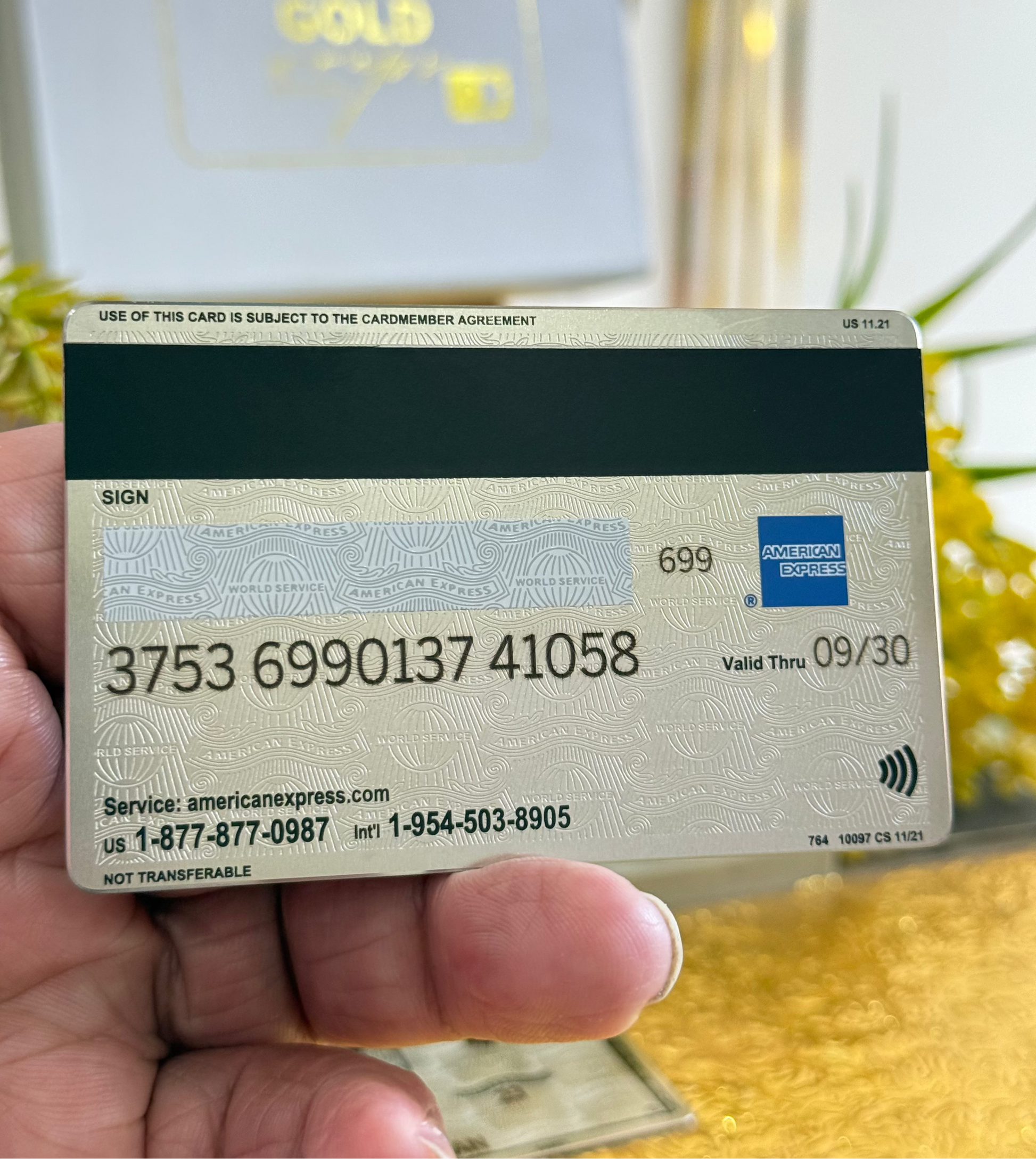 backside of platinum amex metal card by gold wraps