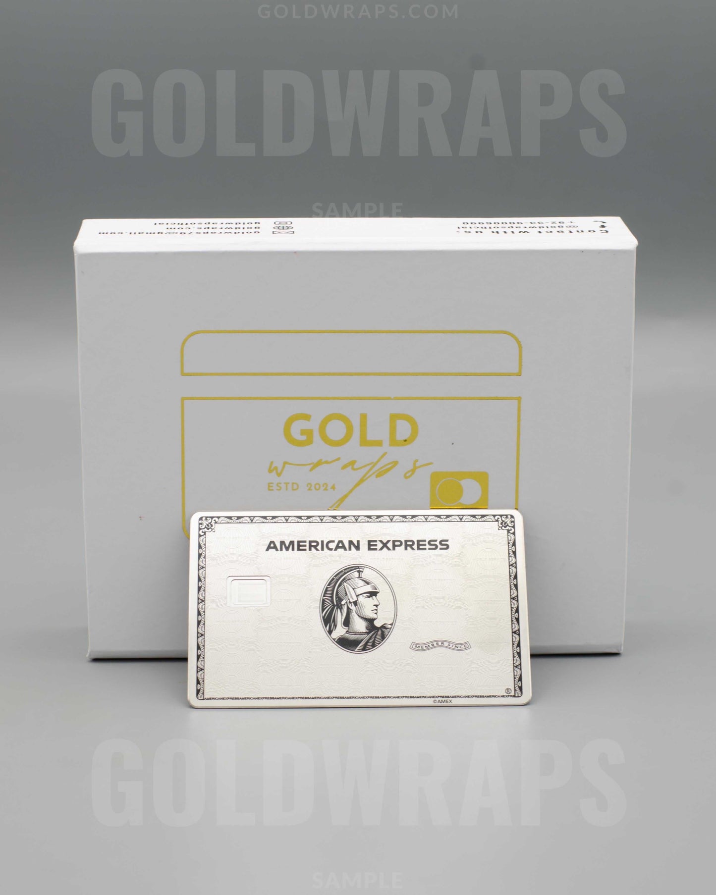 American Express metal card in front of Goldwraps branded box on gray background