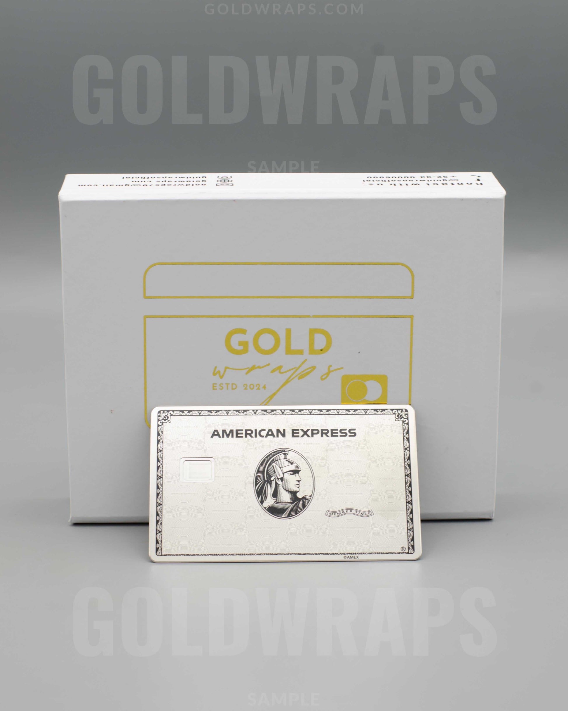 American Express metal card in front of Goldwraps branded box on gray background