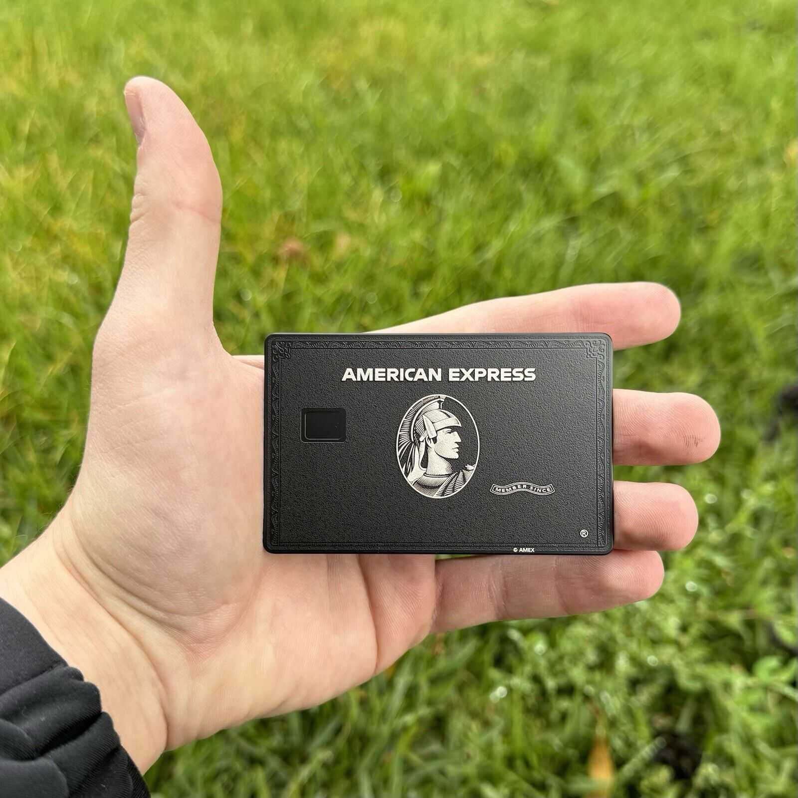 Black AMX metal card in hand - sleek premium design for professionals
